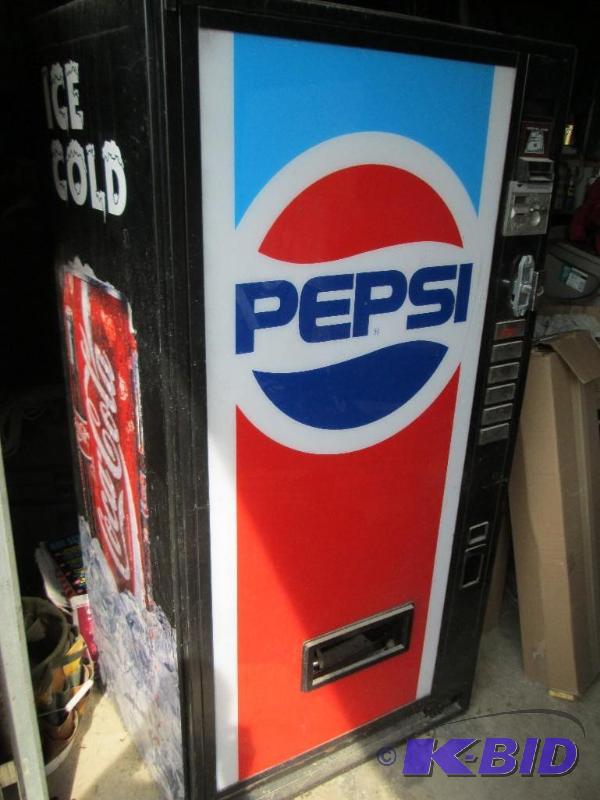 For sale is a Coke machine with a Pepsi plast...