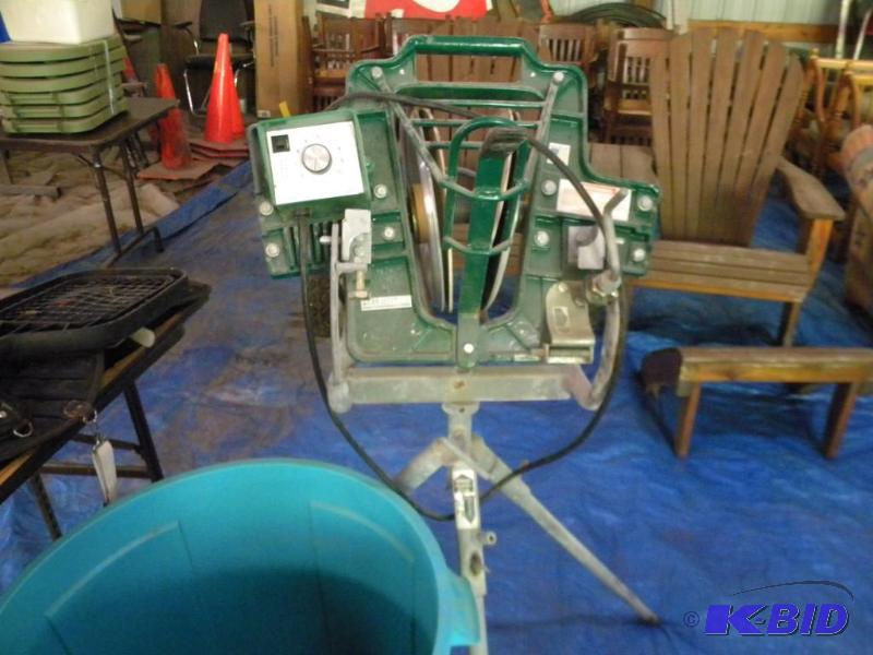 Batting cage and pitching machine