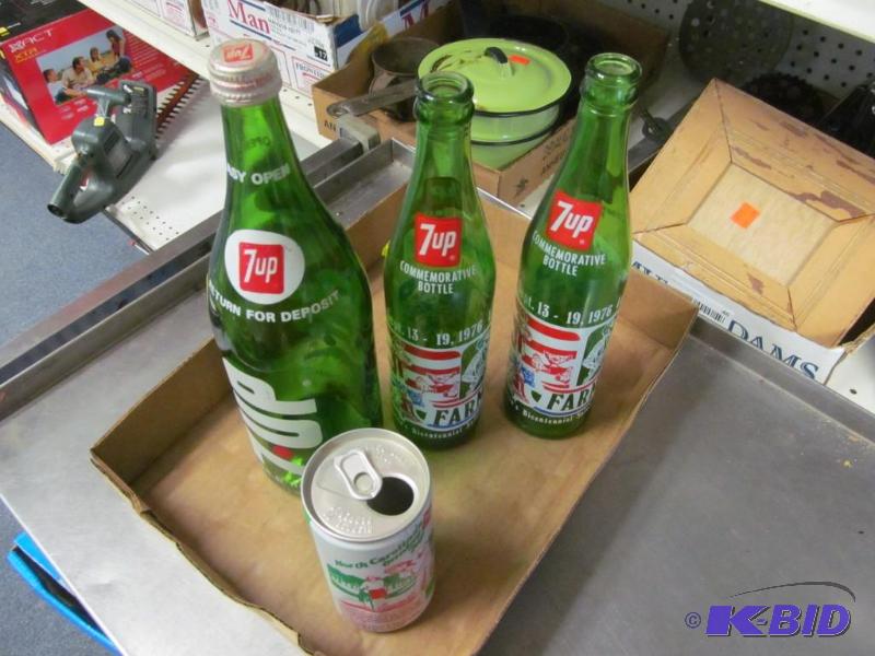 lot 16 image: Lot of 3 vintage 7up bottles and one can.