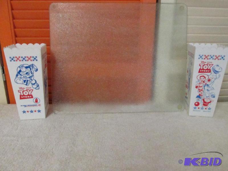lot 125 image: Two Toy Story Popcorn Cups and a Cutting Board.