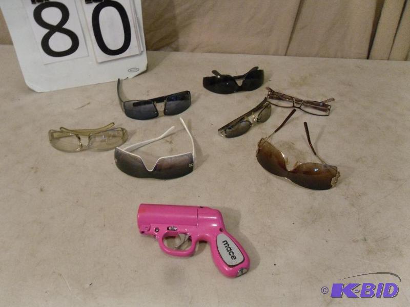 lot 80 image: Pink Mace Gun and Assorted Sunglasses. One pa...