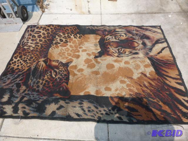 lot 36 image: Area Rug 66" X 90" - has a tear...
