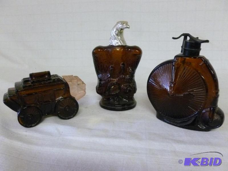 lot 101 image: Lot of three collectible Avon glass cologne c...