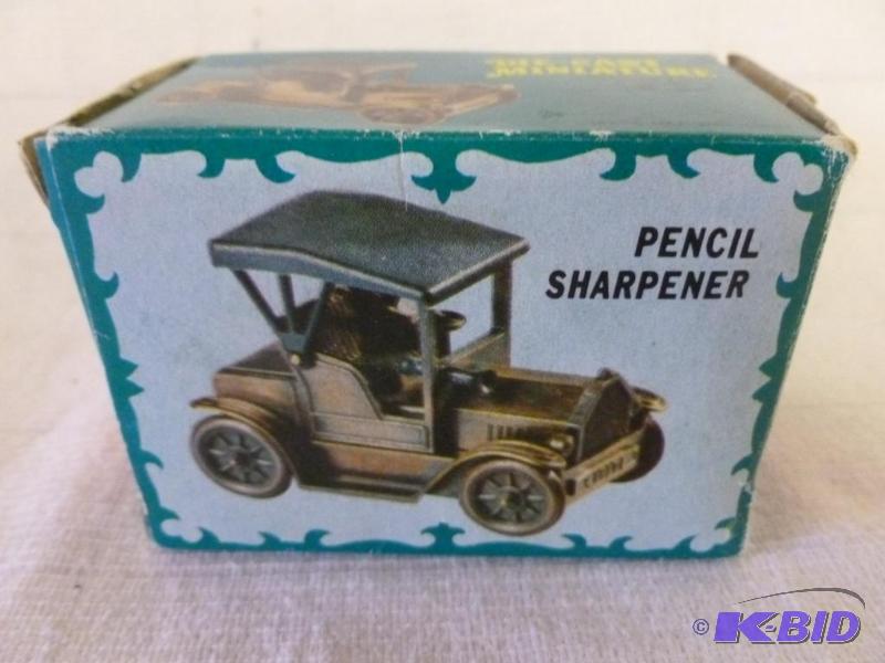 lot 147 image: Die Cast metal old time car pencil sharpener,...