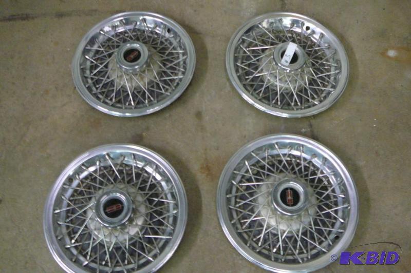 lot 3 image: Wire wheel covers 1980 GM olds cutlas...