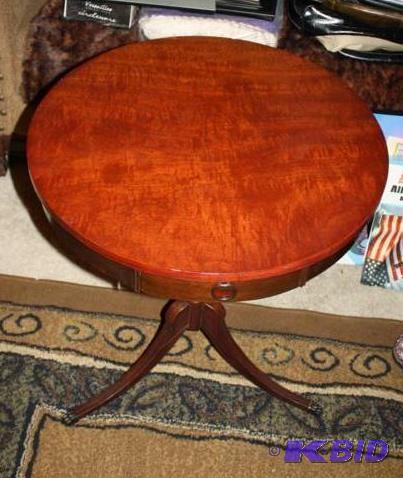 Round table looks like cherry wood with brass...