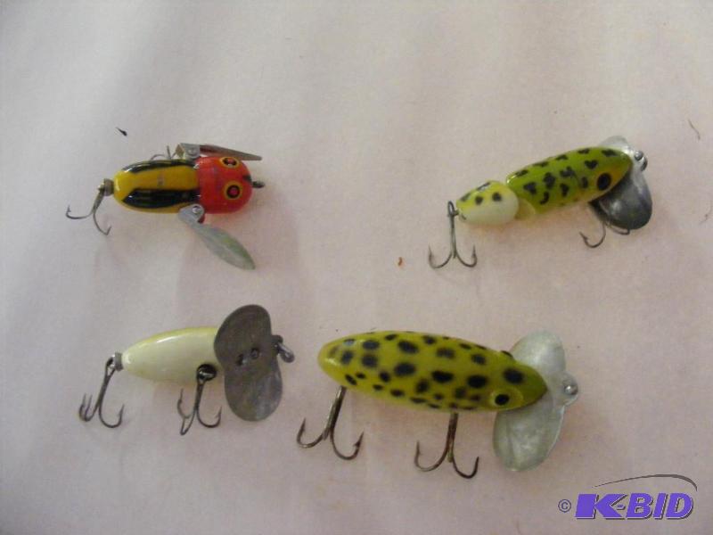4 various lures, one is labeled Heddon Tiny C...