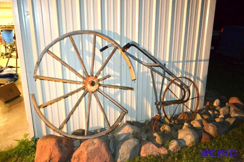 lot 67 image: Antique Wagon Wheel and Farm tiller...