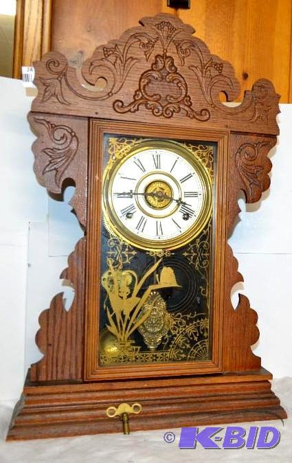 lot 24 image: Antique wood gingerbread clock. Eight day, ha...