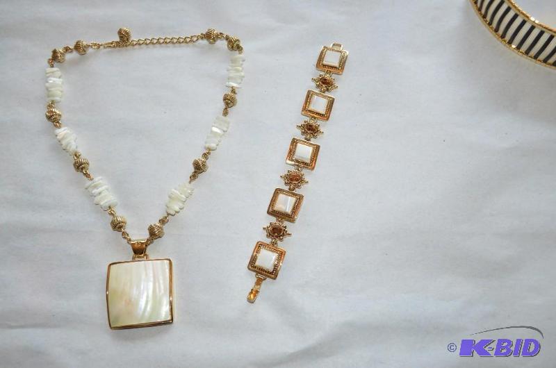 lot 13 image: White flat tooth looking beads with gold col...