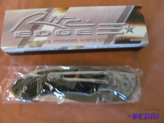 lot 21 image: Brand new in box, retractable pocket knife, R...