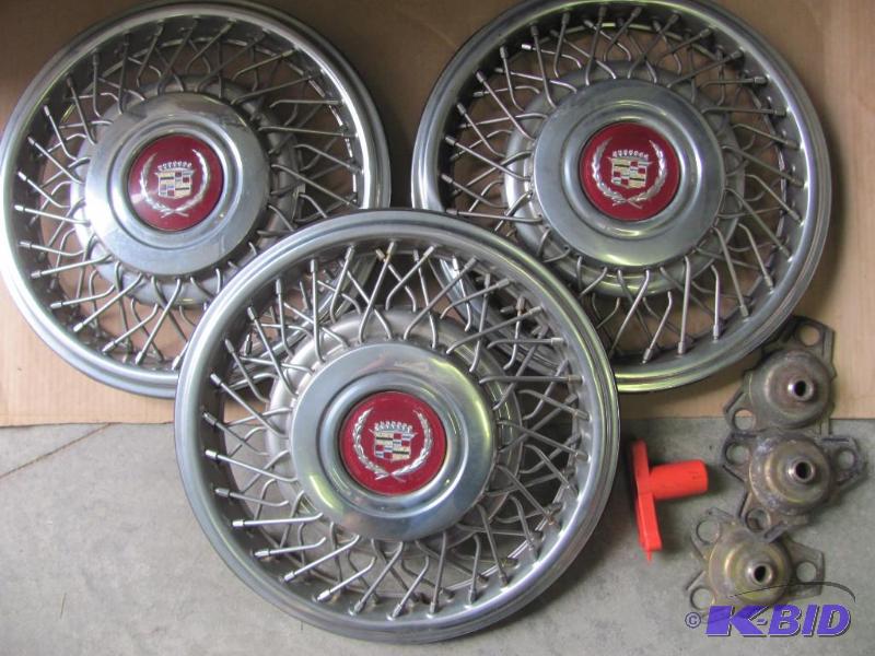 lot 115 image: Three (3) Cadillac Hub Caps and accessories a...