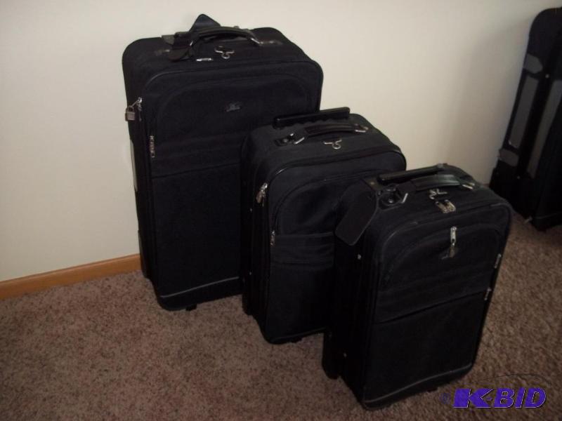 3 matching Black luggage on wheels...