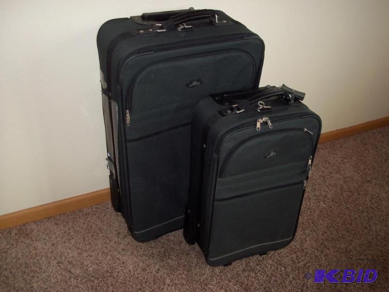 Pair of matching dark green luggage on wheels...