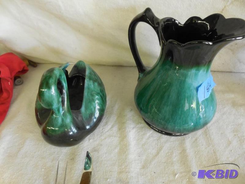 Greenish colored pitcher and decorative swan....