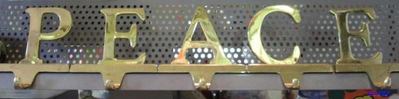 golden letters that spell PEACE, bookshelf dc...