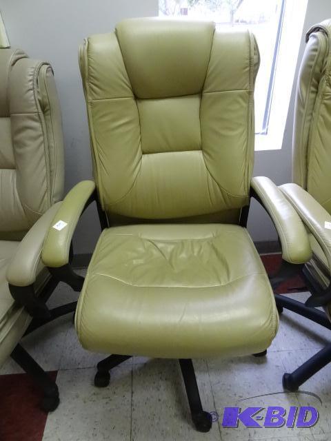 lot 2 image: Leather office chair on wheels. Adjustable he...