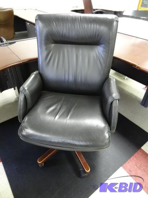 lot 23 image: Leather office chair on wheels. Adjustable he...