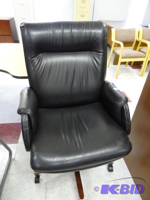 lot 58 image: Leather office chair on wheels. Adjustable he...