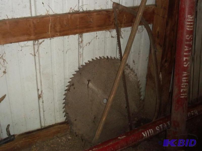 lot 16 image: Large circular saw blade, Bow Handsaw and pol...