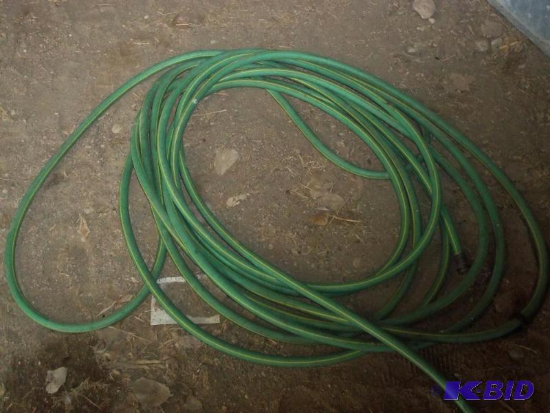 lot 42 image: Green garden hose...