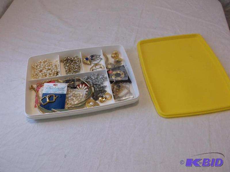 lot 18 image: Plastic container full of jewelry....