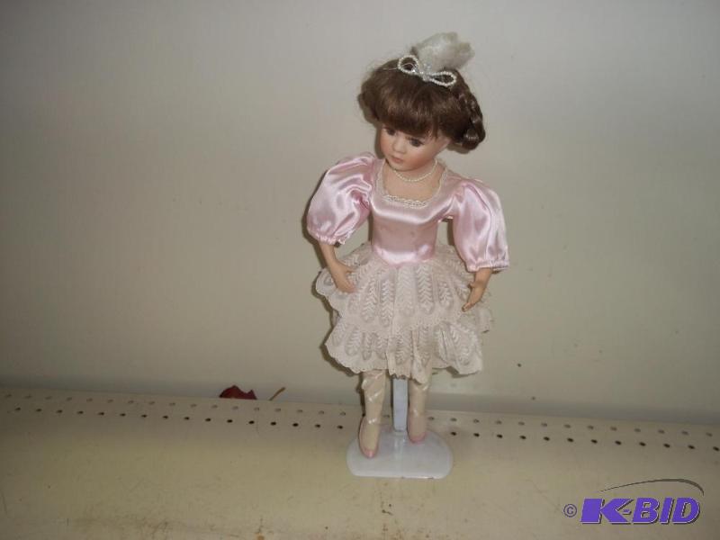 lot 195 image: Porcelain Doll with Stand   Pink dress ...