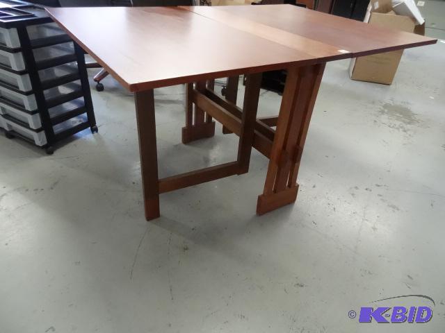 lot 135 image: Fold up wood table. 54 x 36 total size...