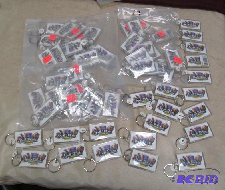 Qty 57 key chains that say North Dakota the S...