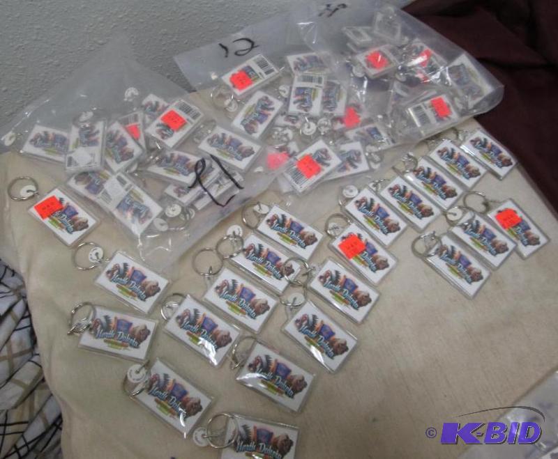Qty 57 key chains that say North Dakota the S...