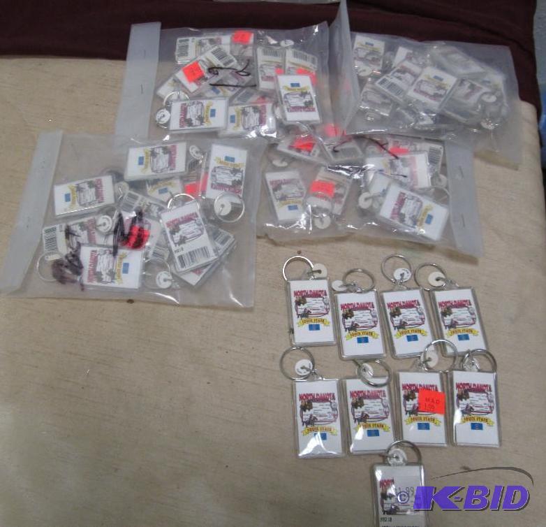 Qty 57 key chains that says North Dakota Soui...