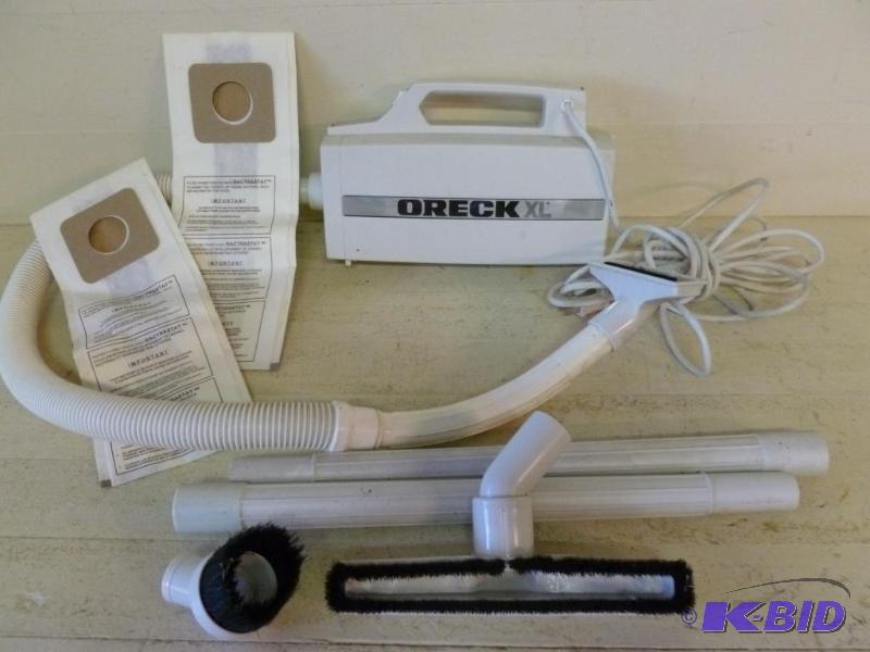 lot 97 image: Oreck XL hand canister vacuum with attachment...