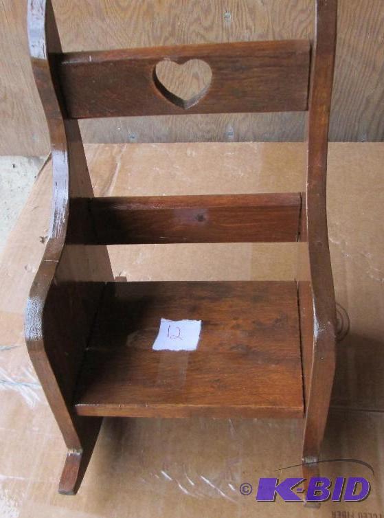 wooden rocking chair with heart caved into ba...