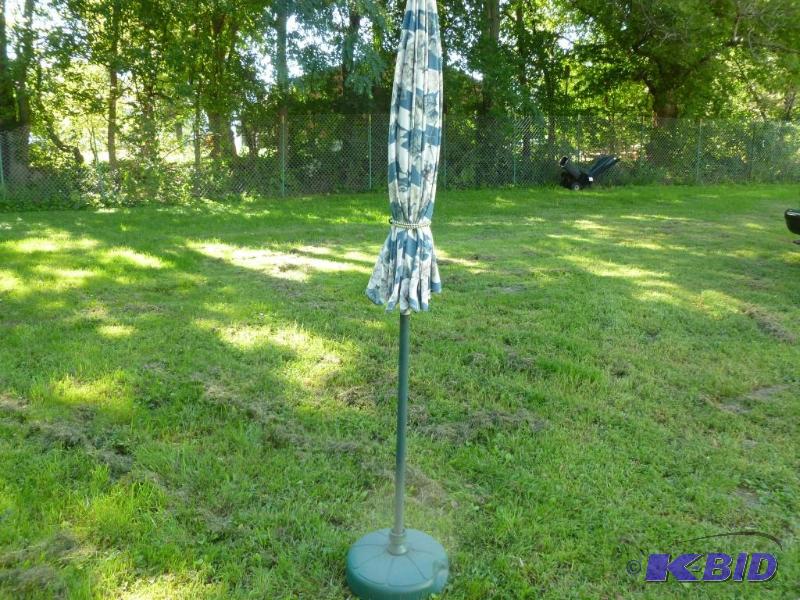 Large patio umbrella with stand, appears to b...