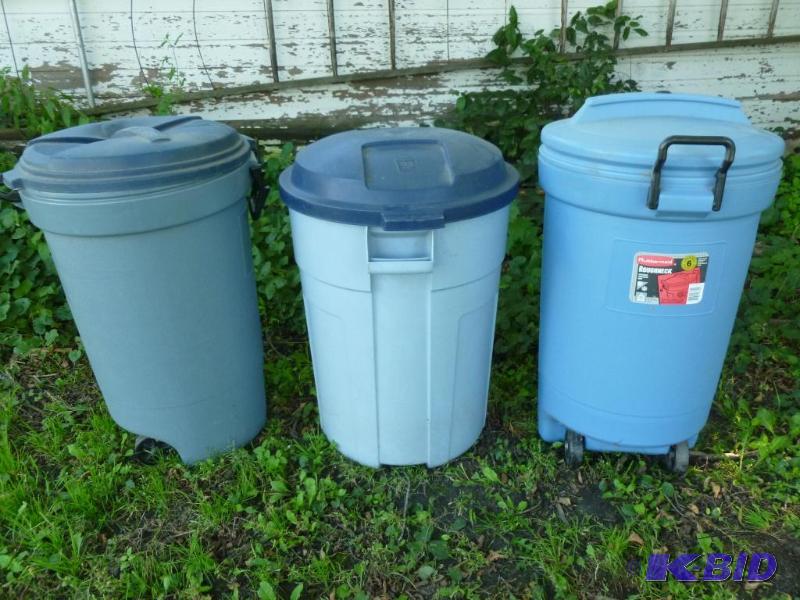 Lot of three large garbage cans with lids, al...