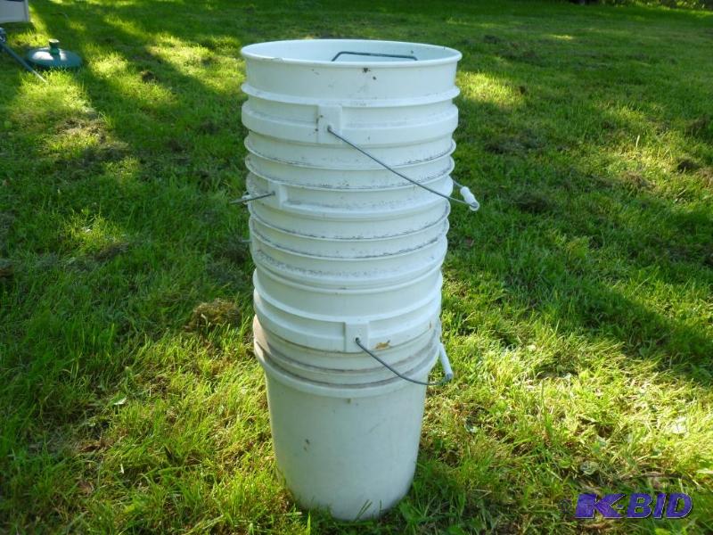 A stack of five - 5 gallon plastic pails with...