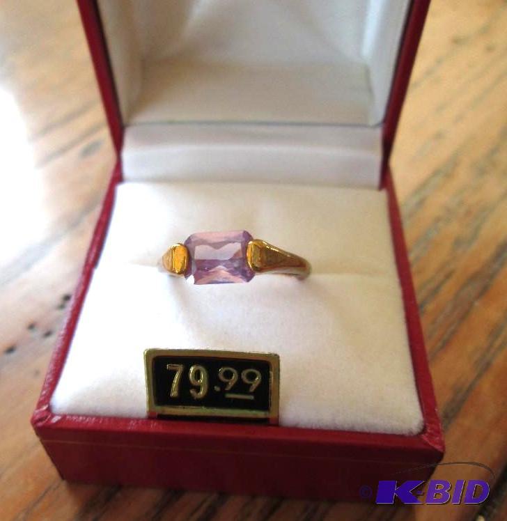 lot 287 image: Gold colored band ring with rectangular purpl...