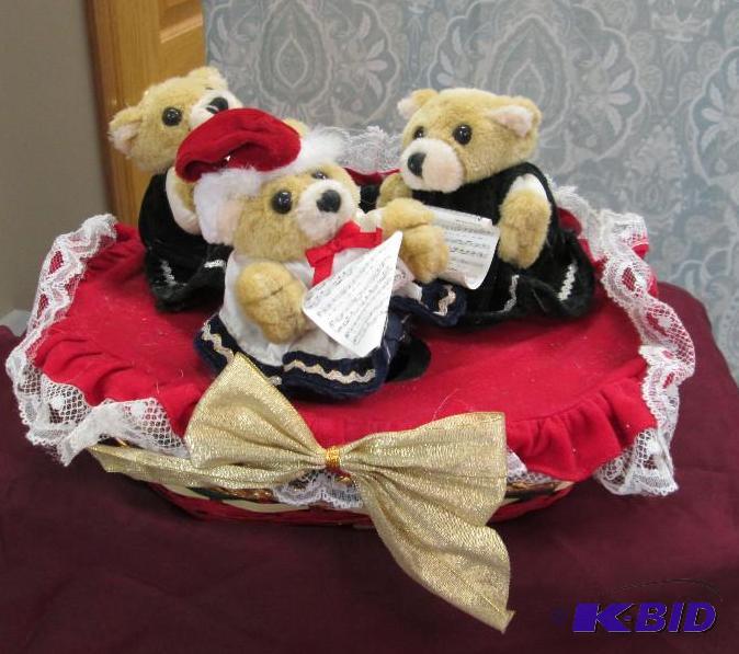 Basket with three bears with sheet music...