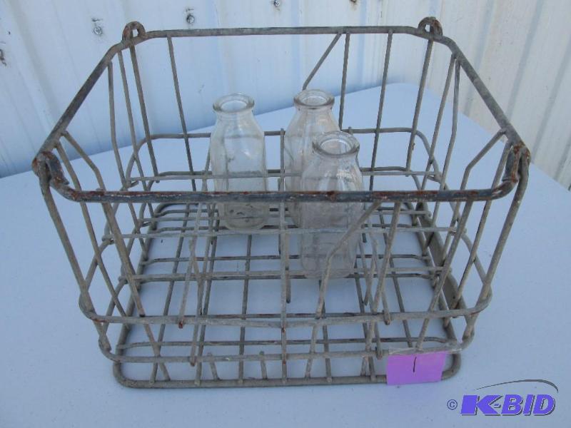 lot 1 image: vintage metal milk crate with 3 glass bottles...