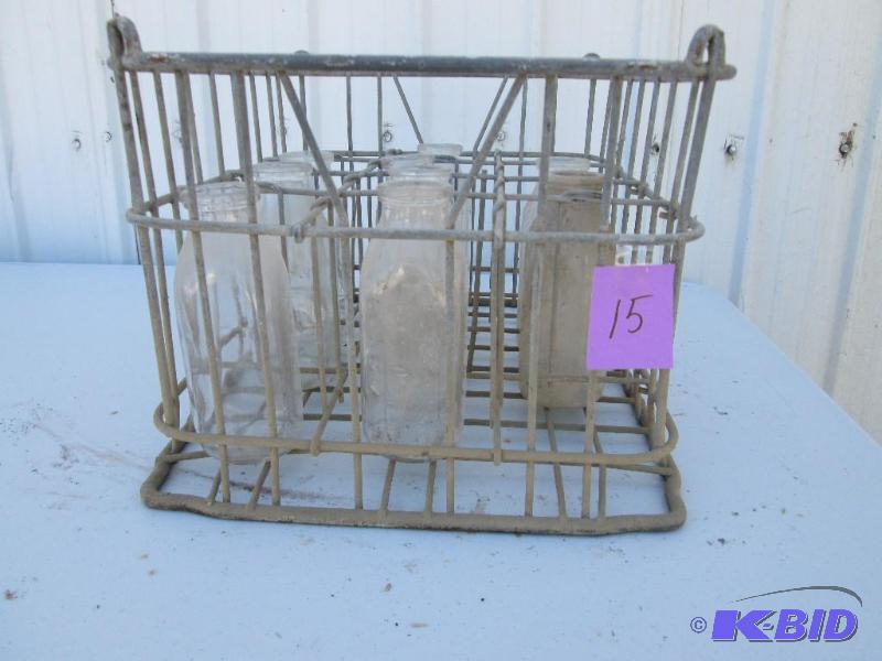 lot 15 image: vintage metal milk crate with 9 glass bottles...
