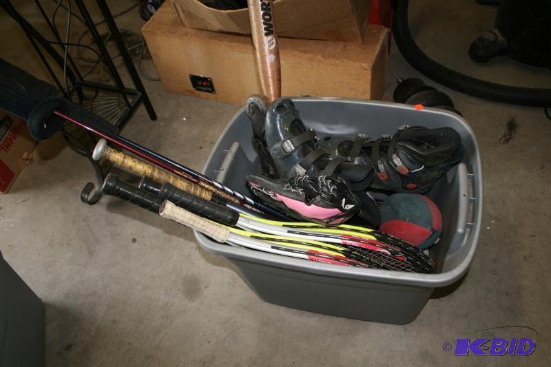 Bin of sporting equipment, rollerblades, bats...