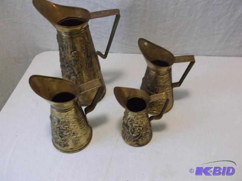 lot 25 image: Lot of 4 embossed brass plated pitchers appea...
