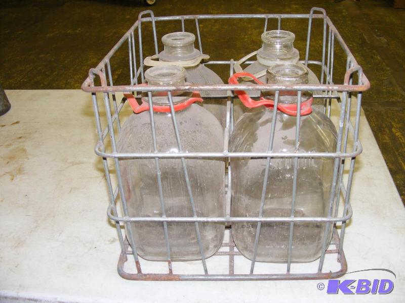 4 gallon glass milk bottles in crate...