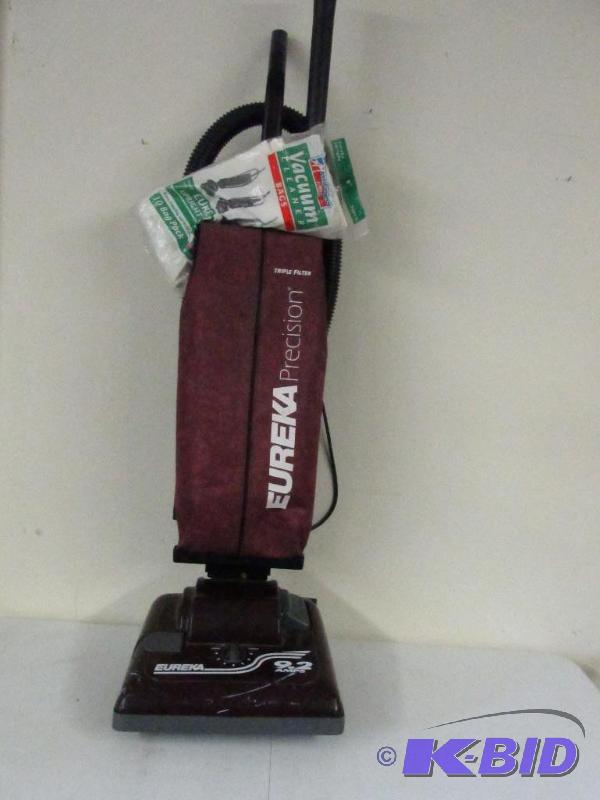 lot 118 image: Eureka Up Right Vacuum with On Board Attachments.