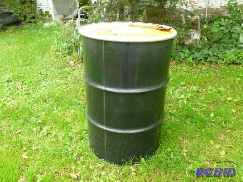 Large 55 gallon steel drum with lid, was fill...