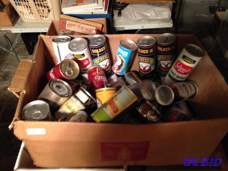 lot 142 image: Box of sealed empty cans and banks.