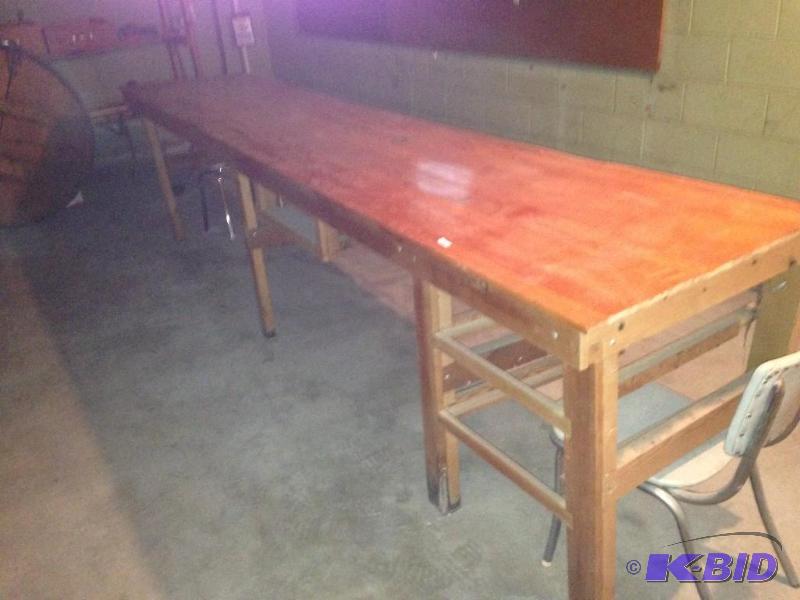 lot 156 image: Long work bench made of Maple.  Looks lie a bowling alley.  Will require two people to get out so bring help.  We will not have help available.  Item is located in a basement.  147 x 30 x 37 inches tall.