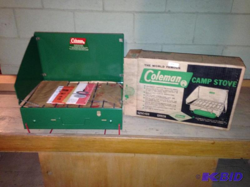 lot 157 image: Vintage Coleman Camp Stove IN ORIGINAL BOX - NEVER USED.  This was made in 1961, 1963 or 1964 making it over 50 years old.  This has never been completely unwrapped.  Has the gas tank so it is complete.  You will NEVER find one in better condition.