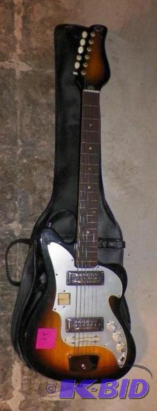 lot 24 image: 1960s Zenion Electric Guitar with original case and cord.  Nice old Wood Body Guitar.