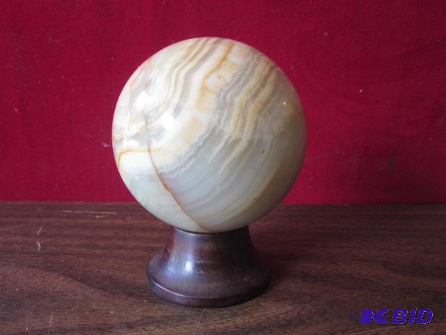 Round and heavy Alabaster stone ball, on wood...